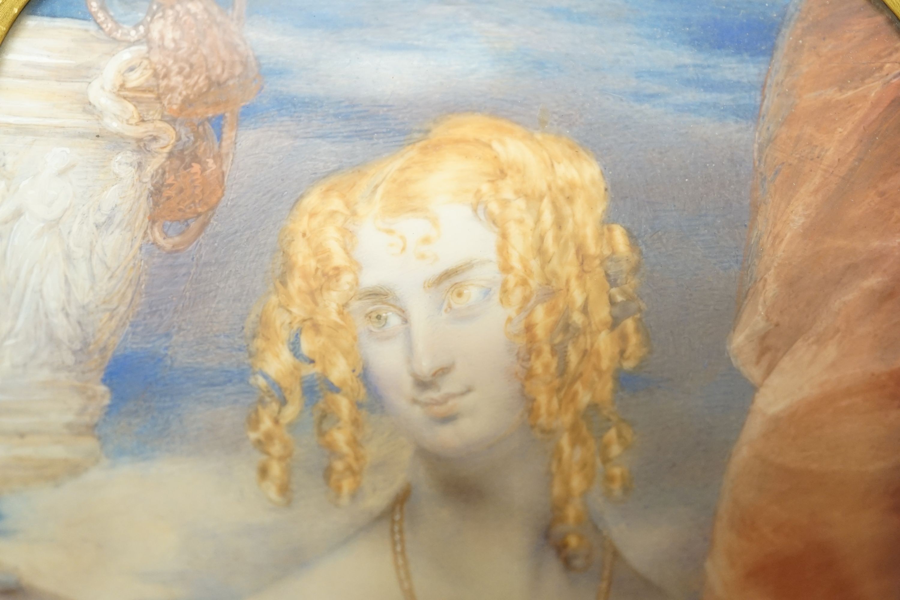 19th century ormolu framed portrait miniature on ivory of a young lady with auburn hair. Length of frame - 23cm